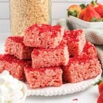Strawberry Rice Krispie treats cut into bars on a white platter.