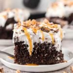 Slice of better than sex cake on a white plate.