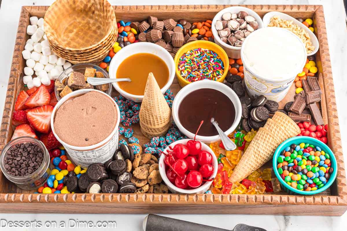 Charcuterie board with ice cream and toppings ready to enjoy.