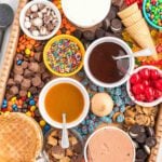 An overhead shot of a tray of ice cream toppings.