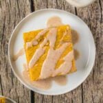 Pumpkin cake cut into a square and served on a plate.