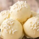 White chocolate truffles stacked together.