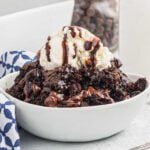Chocolate dump cake in a bowl with ice cream.