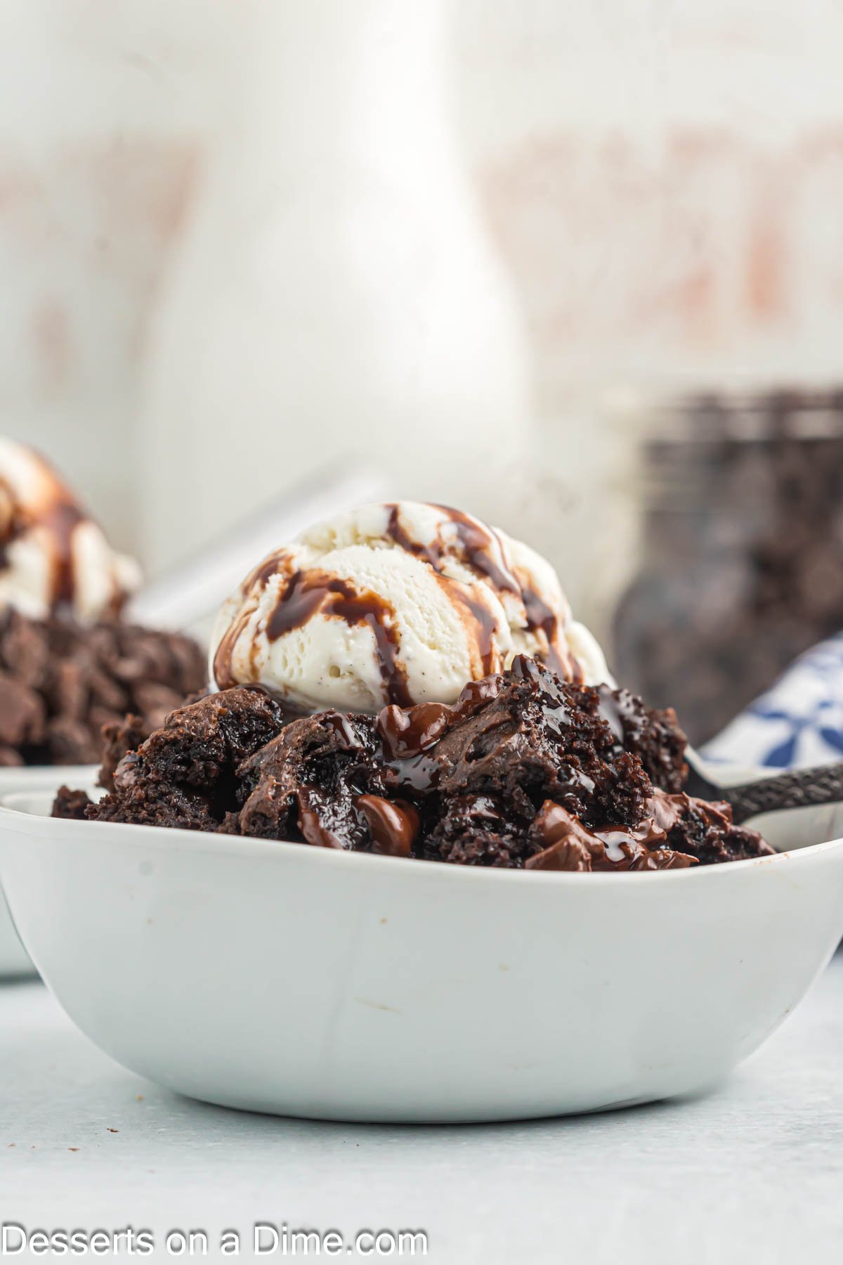 Bowl of cake topped with ice cream.