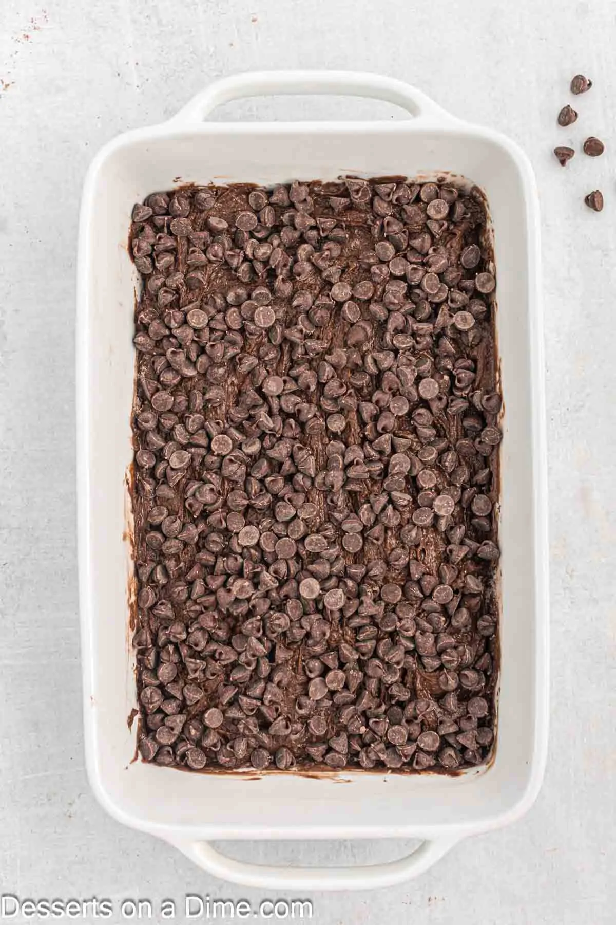 Chocolate chips spread on top of cake mix.