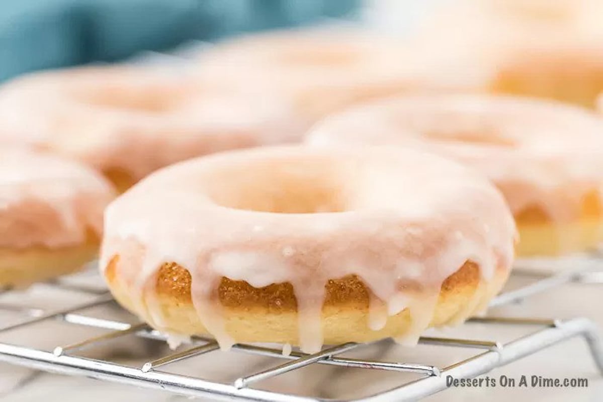 Glazed donuts on wire rack.