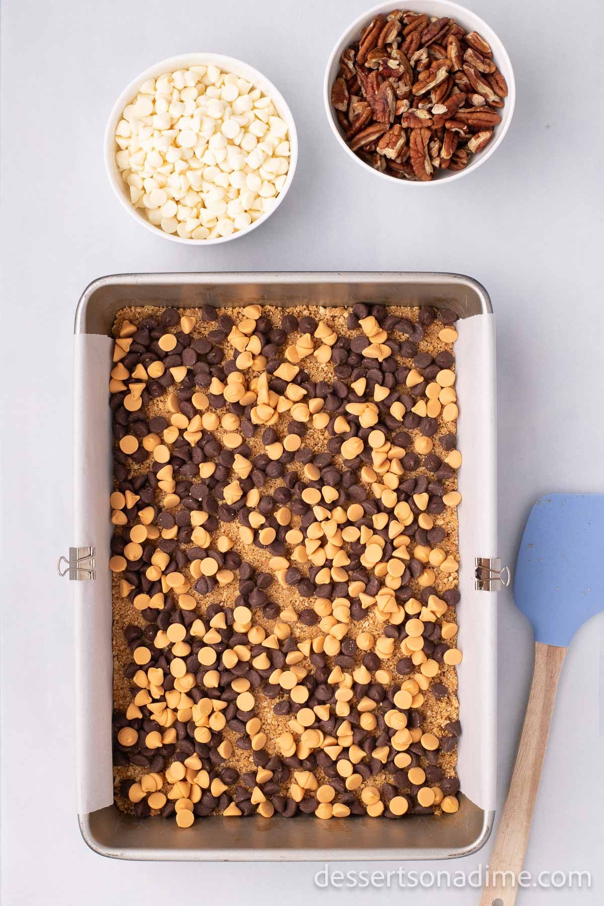 The butterscotch chips spread in an even layer on top of the graham cracker crumb crust.  