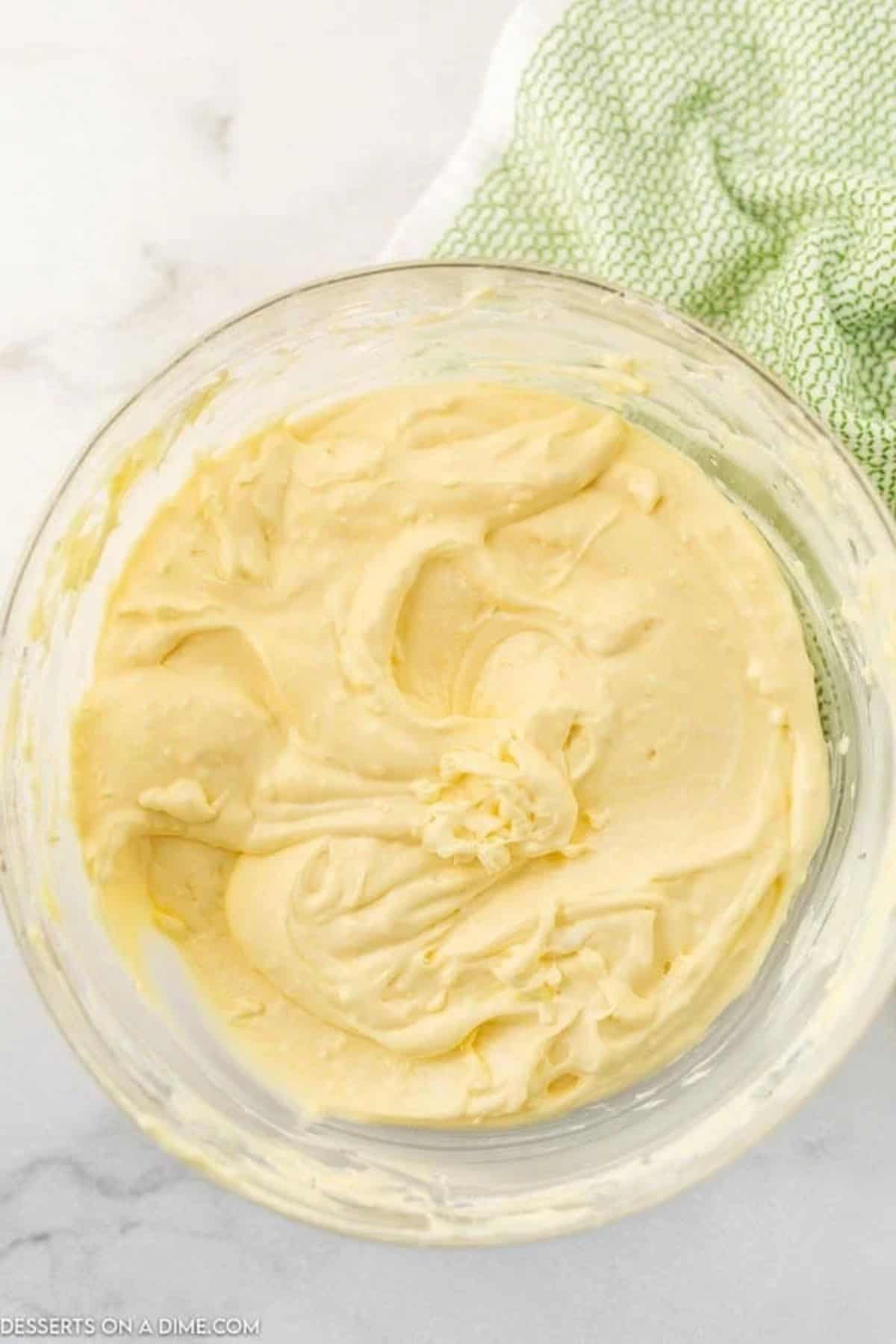 Pudding mixture combined in cream cheese mixture in a mixing bowl. 