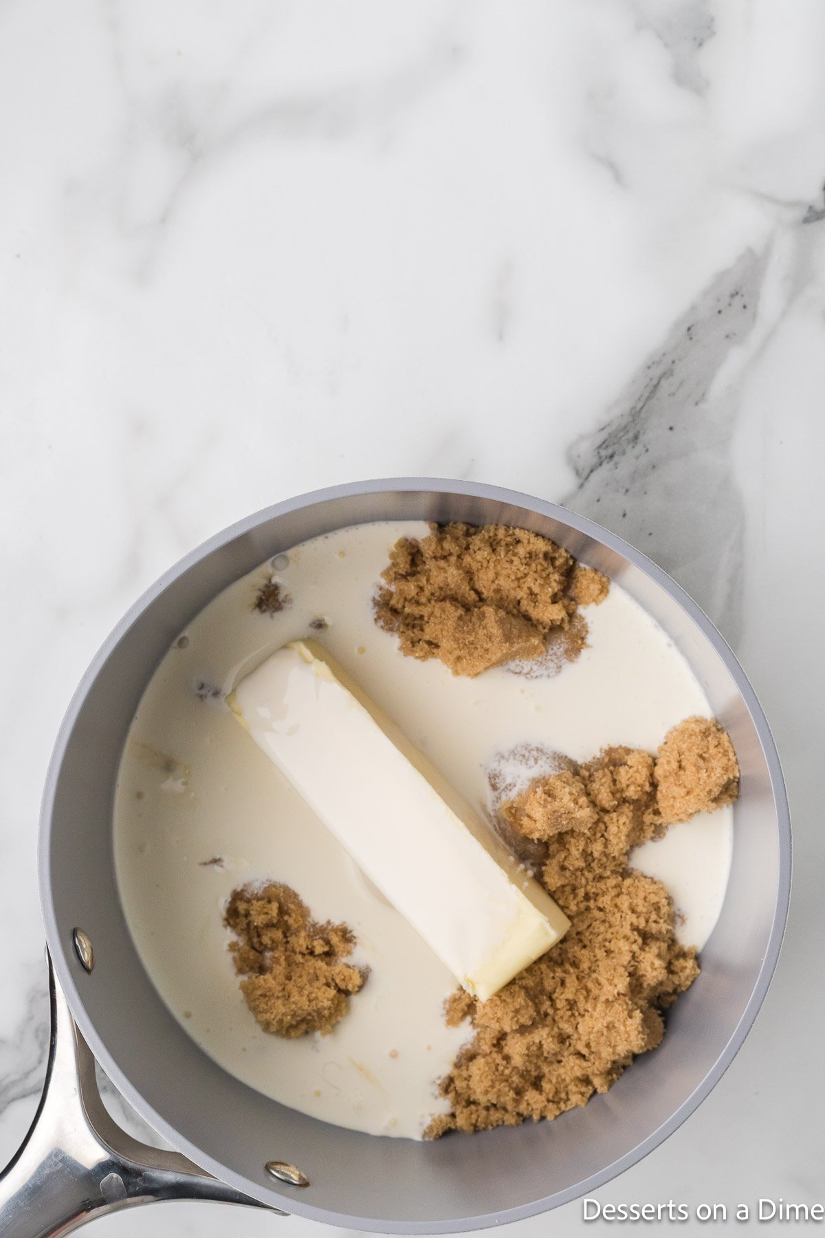 Saucepan with butter, heavy cream and brown sugar. 