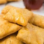 Sopapillas on plate with honey.