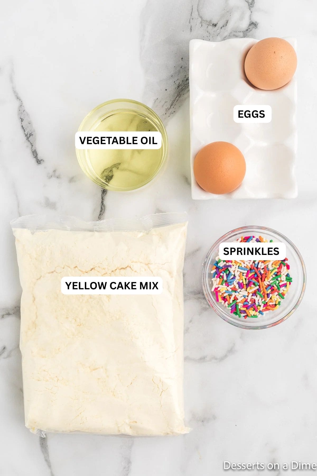 Ingredients for recipe, vegetable oil, eggs, yellow cake mix and sprinkles. 