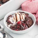 Chocolate Cherry Dump Cake in a bowl with ice cream.