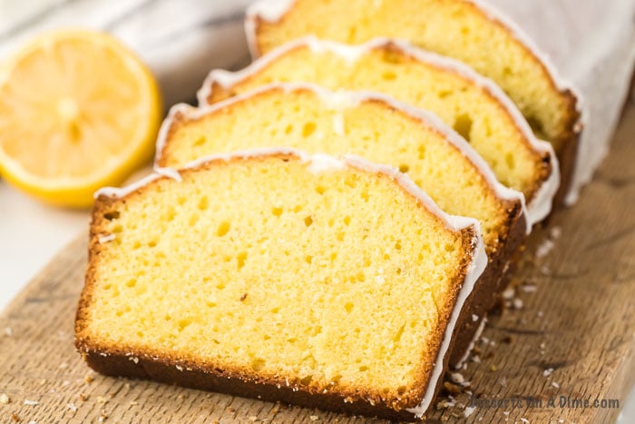 Lemon loaf sliced on a wooden board. 