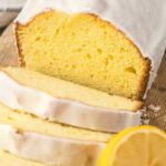 Lemon pound cake with white icing and lemon slices, perfect for dessert recipes.