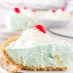 Slice of kool aid pie on a plate.