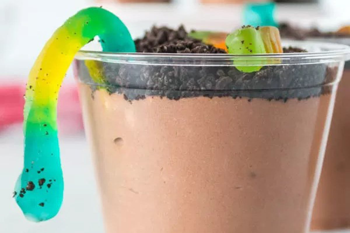 Pudding Cup topped with crushed oreo cookies and gummy worms.