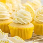 Lemon cupcakes topped with lemon slices.