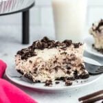 A slice of oreo pie on a plate with a fork.