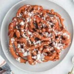 Funnel cake topped with powdered sugar.