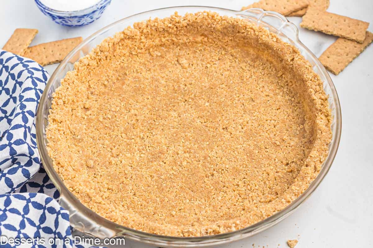 Graham cracker pie crust in a pie dish.