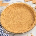 Graham cracker pie crust in a pie dish.
