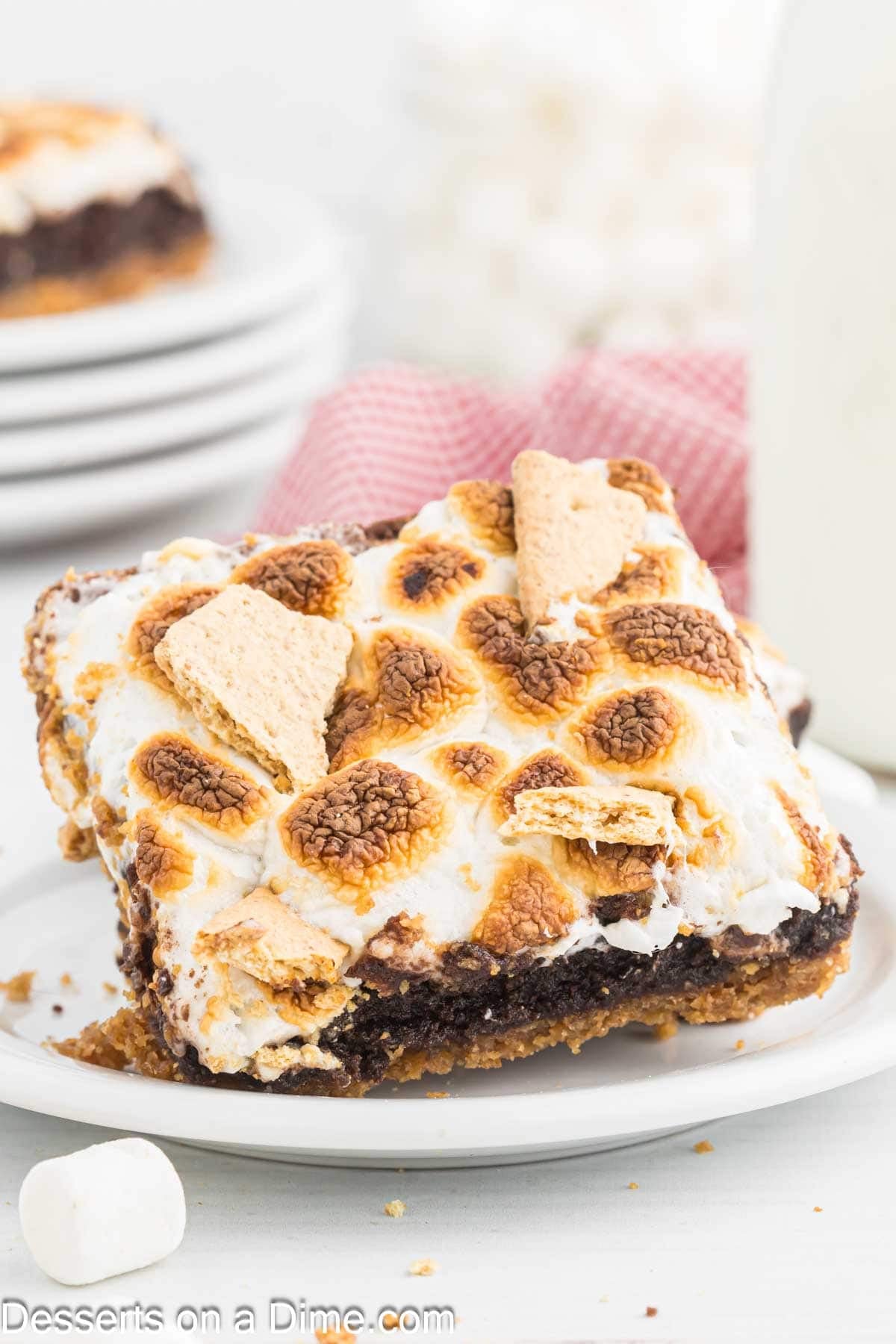 Slice of s'mores brownies on white plate.