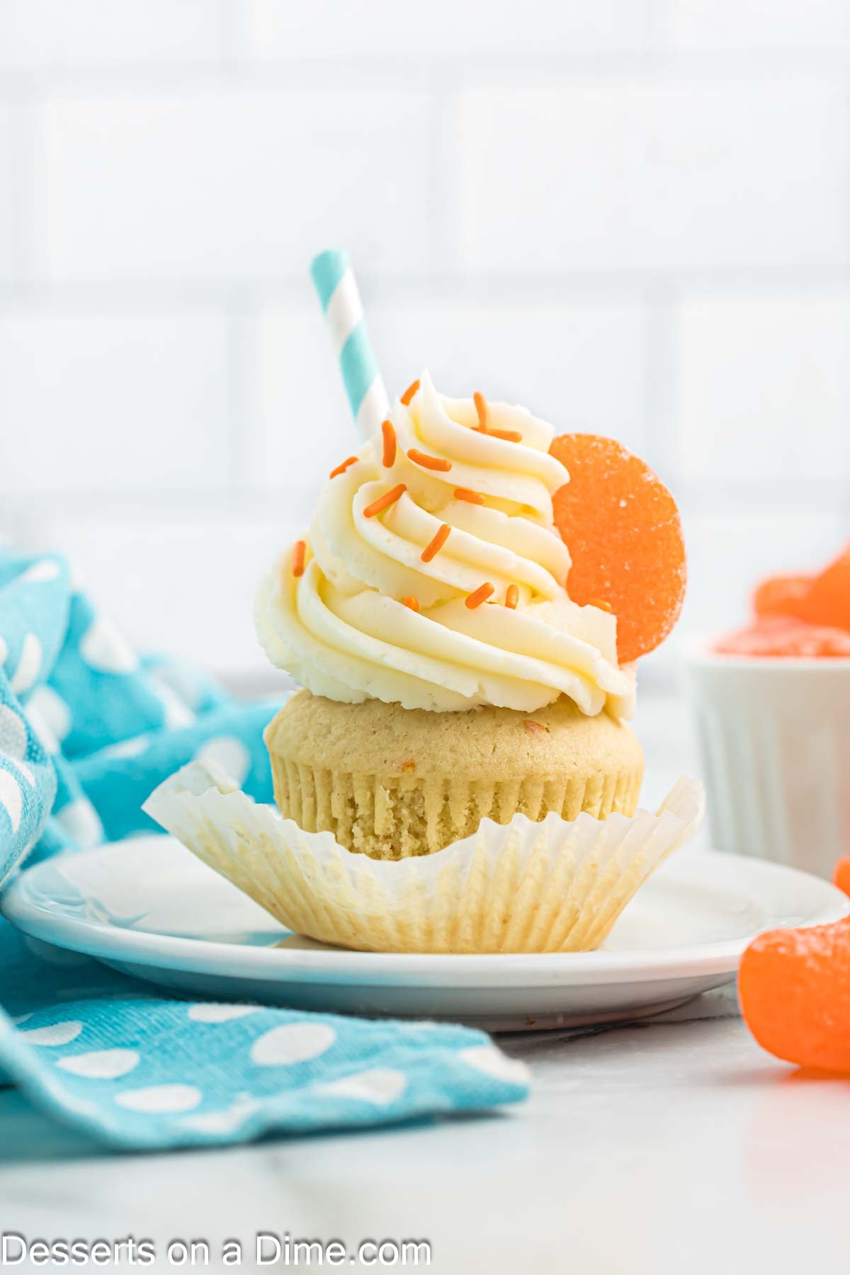 Cupcake topped with frosting on plate. 