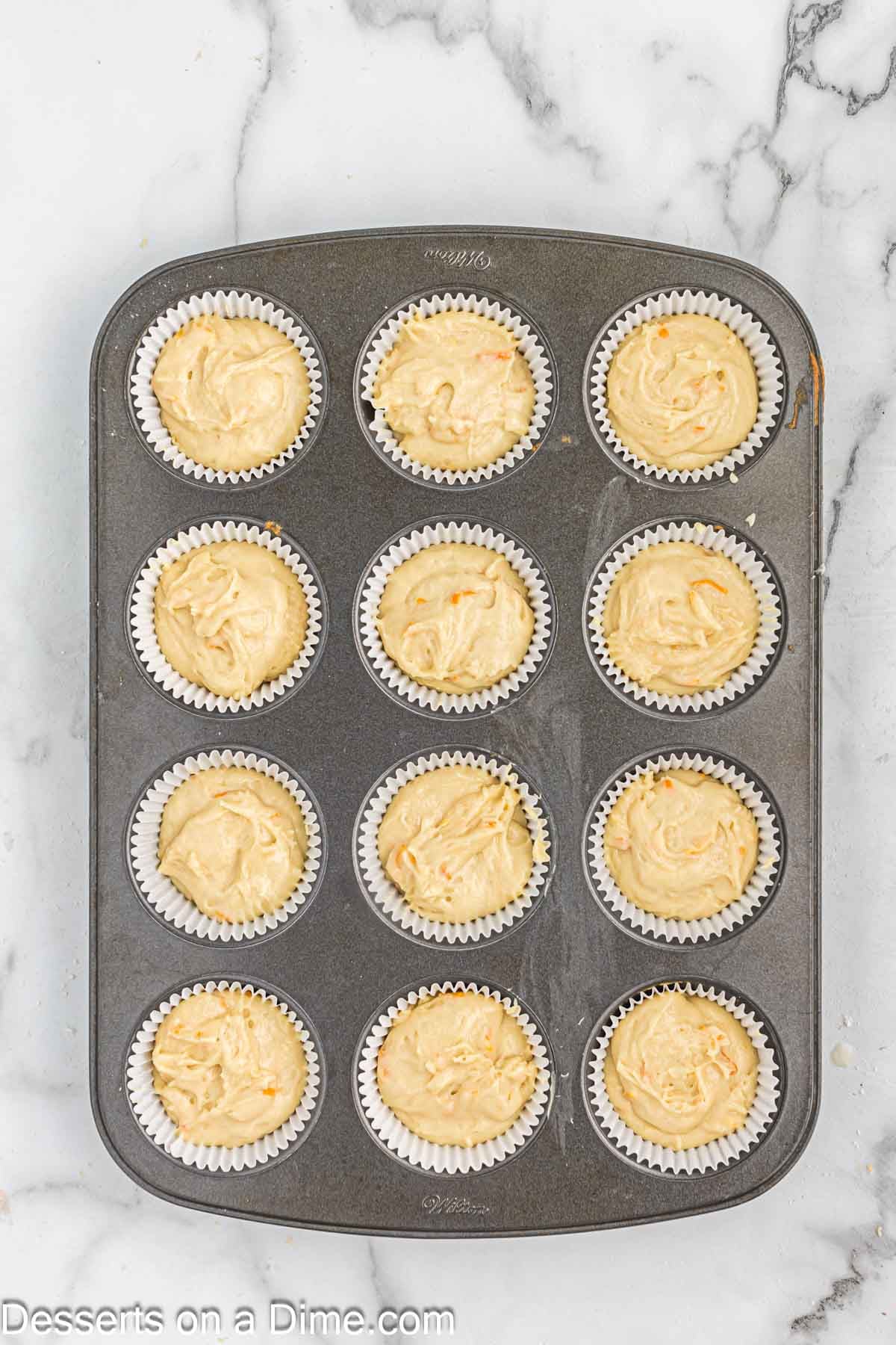 Batter in cupcake liners. 