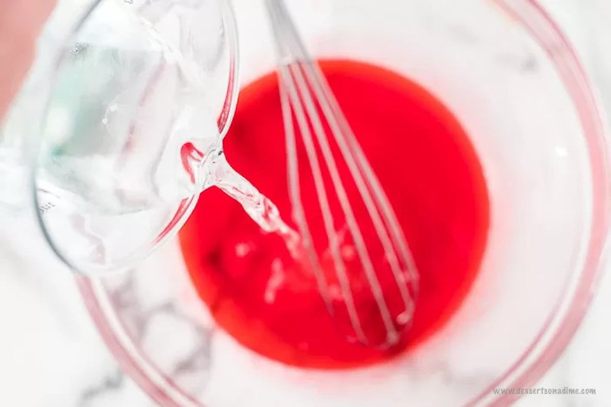 Pouring in the boiling water with jello in a bowl