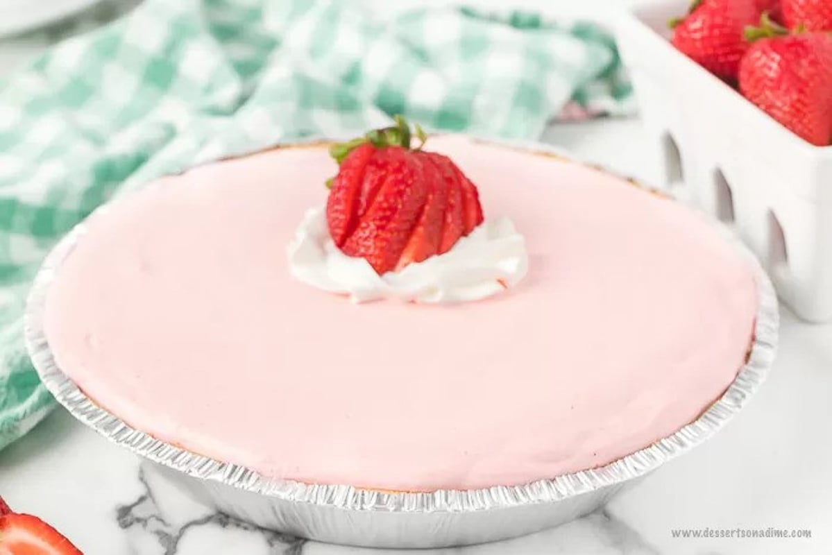 A whole Strawberry Pie with Slice Strawberries on top.