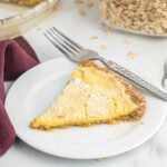 A slice of crack pie on a plate with a fork.