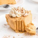 Pumpkin pie cheesecake sliced on a plate.