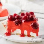 No bake cheesecake with cherries on a plate.