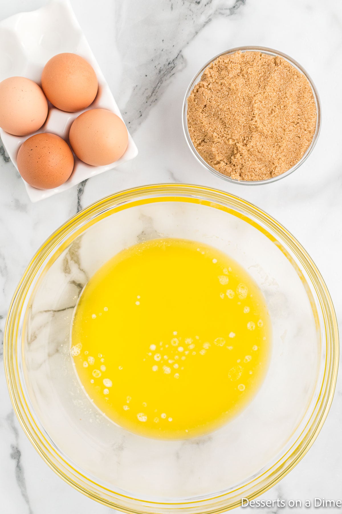 Mixing bowl with melted butter, eggs and sugar. 