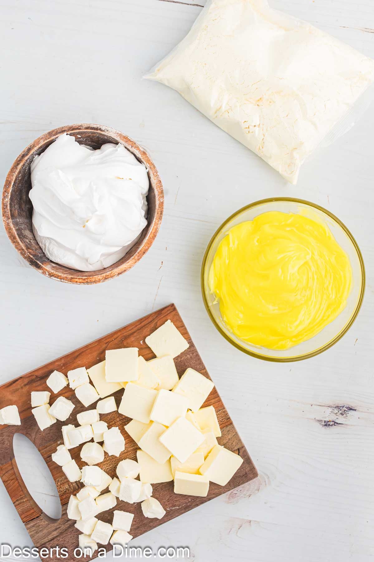 Ingredients for Lemon Dump Cake - yellow box cake mix, cream cheese, butter, cool whip. 