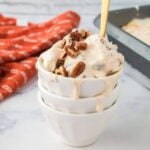 Creamy pecan ice cream in a white bowl with pecan toppings, perfect for budget-friendly desserts.