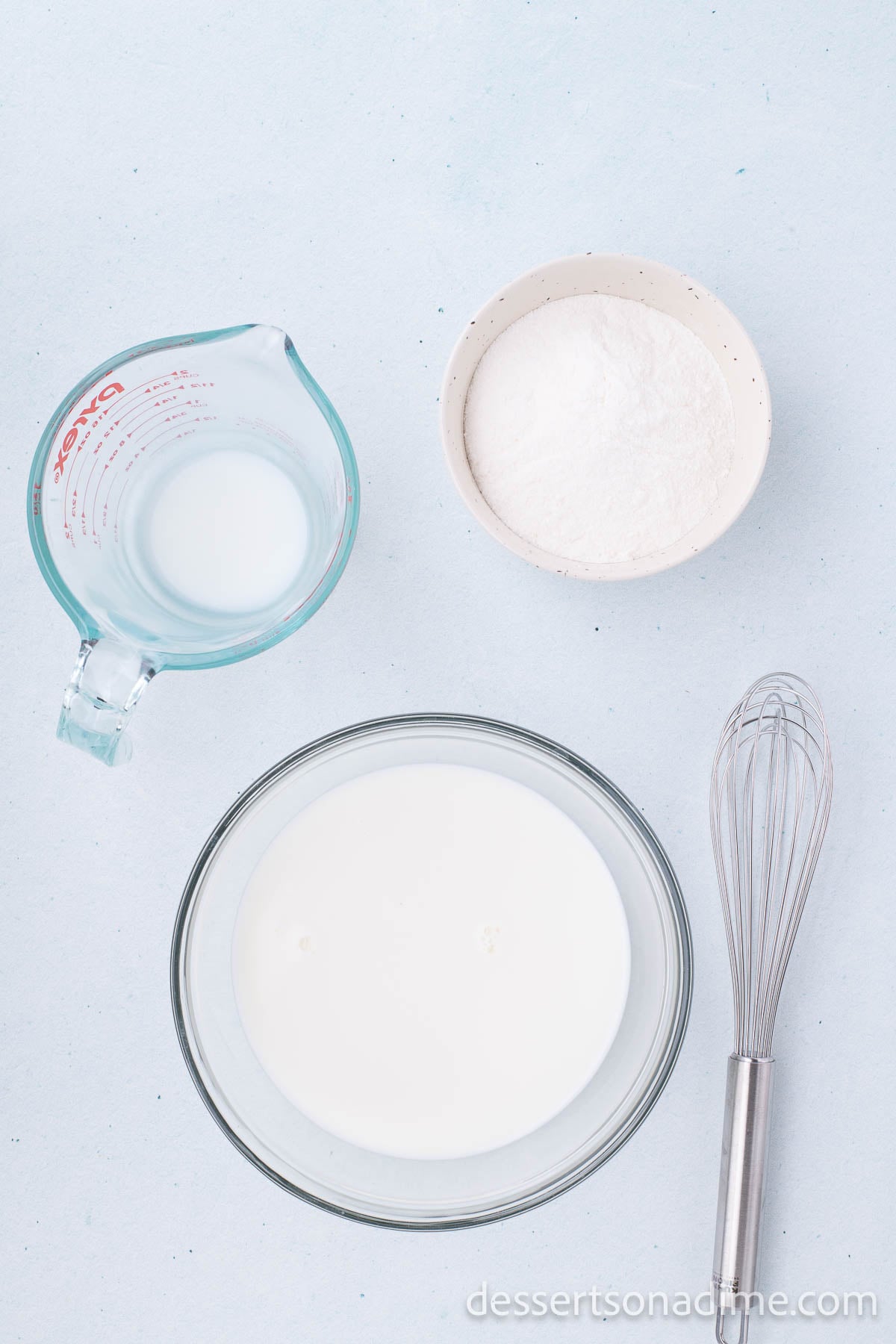 Pudding mix and milk being combined in bowl. 