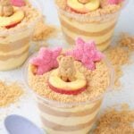 Sand pudding cups in clear cups with teddy grahams on top.