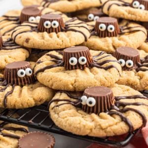 Chocolate peanut butter cookies with eyes and spider legs.