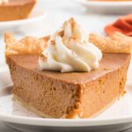 Pumpkin pie with whipped cream.
