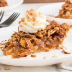 Apple pie with whipped cream and almonds.