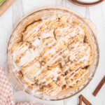 Cinnamon Roll Apple Pie topped with glaze and ready to serve.