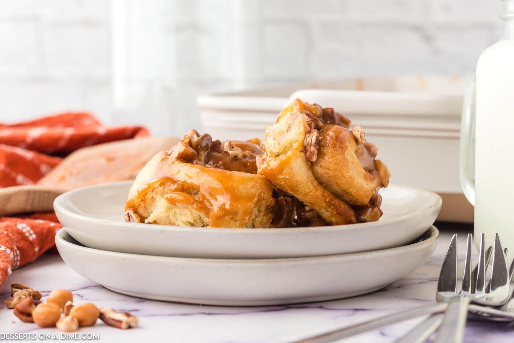 White plate with Caramel Pecan Cinnamon Rolls.