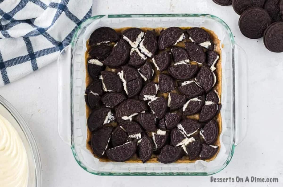 Oreo Cookies layered on top of cookie dough. 