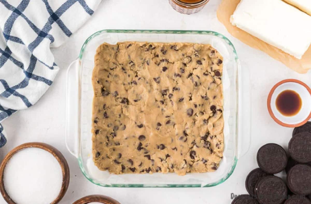 Cookie dough pressed into baking dish. 