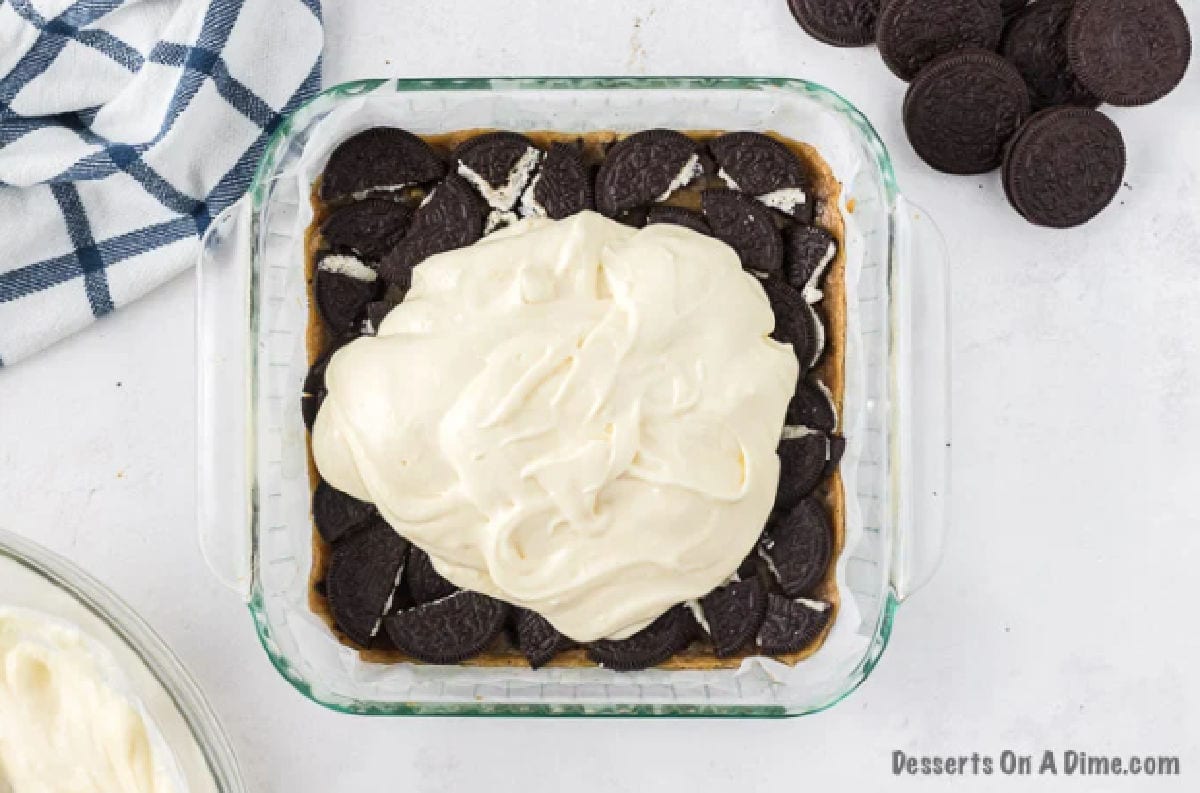 Cheesecake mixture spread over cookies. 