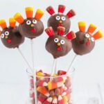 Thanksgiving cake pops in a clear container.