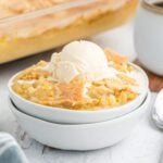 Apple crisp in a bowl with ice cream.