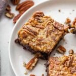 Pecan pie brownies served on a white plate.
