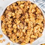 Snickers Popcorn in a white bowl.